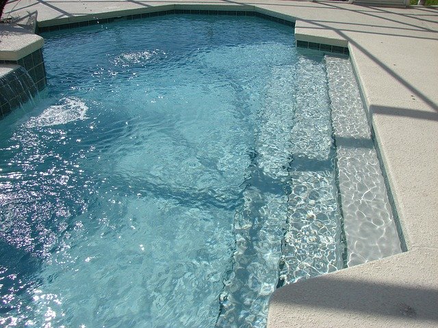 Crystal-clear pool water over clean steps